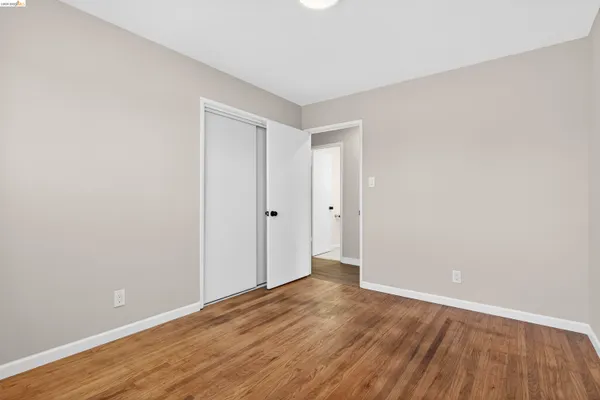 a view of a room with wooden floor and window