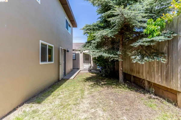 a view of a porch with a floor to ceiling window and potted plants