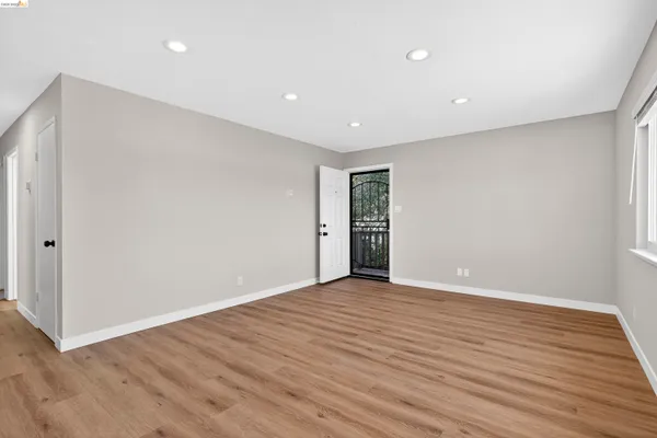 a kitchen with granite countertop white cabinets and wooden floor