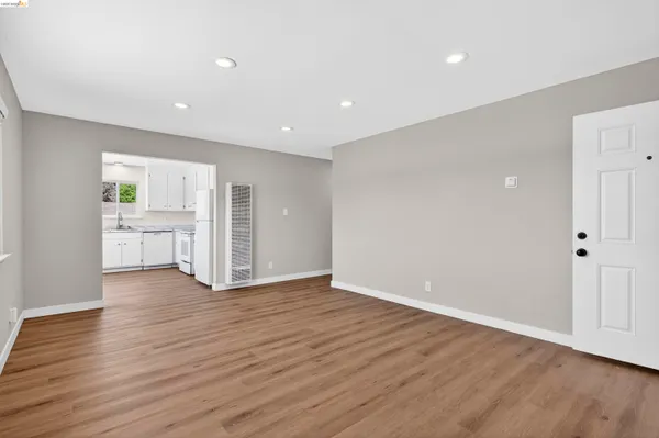 a view of a kitchen with wooden floor and a sink