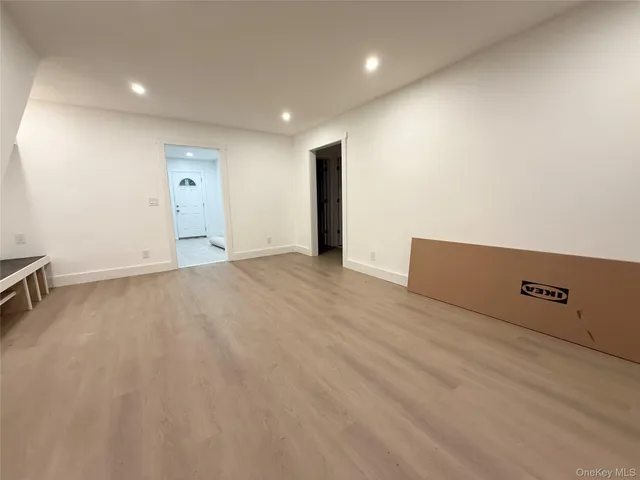 an empty room with cabinet and mirrors