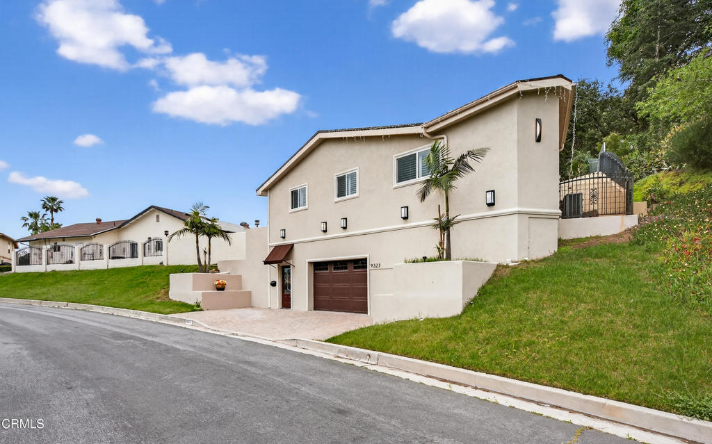 9325 La Shell Drive Tujunga, CA 91042 - Photo 30 of 46 a front view of a house with a yard and garage