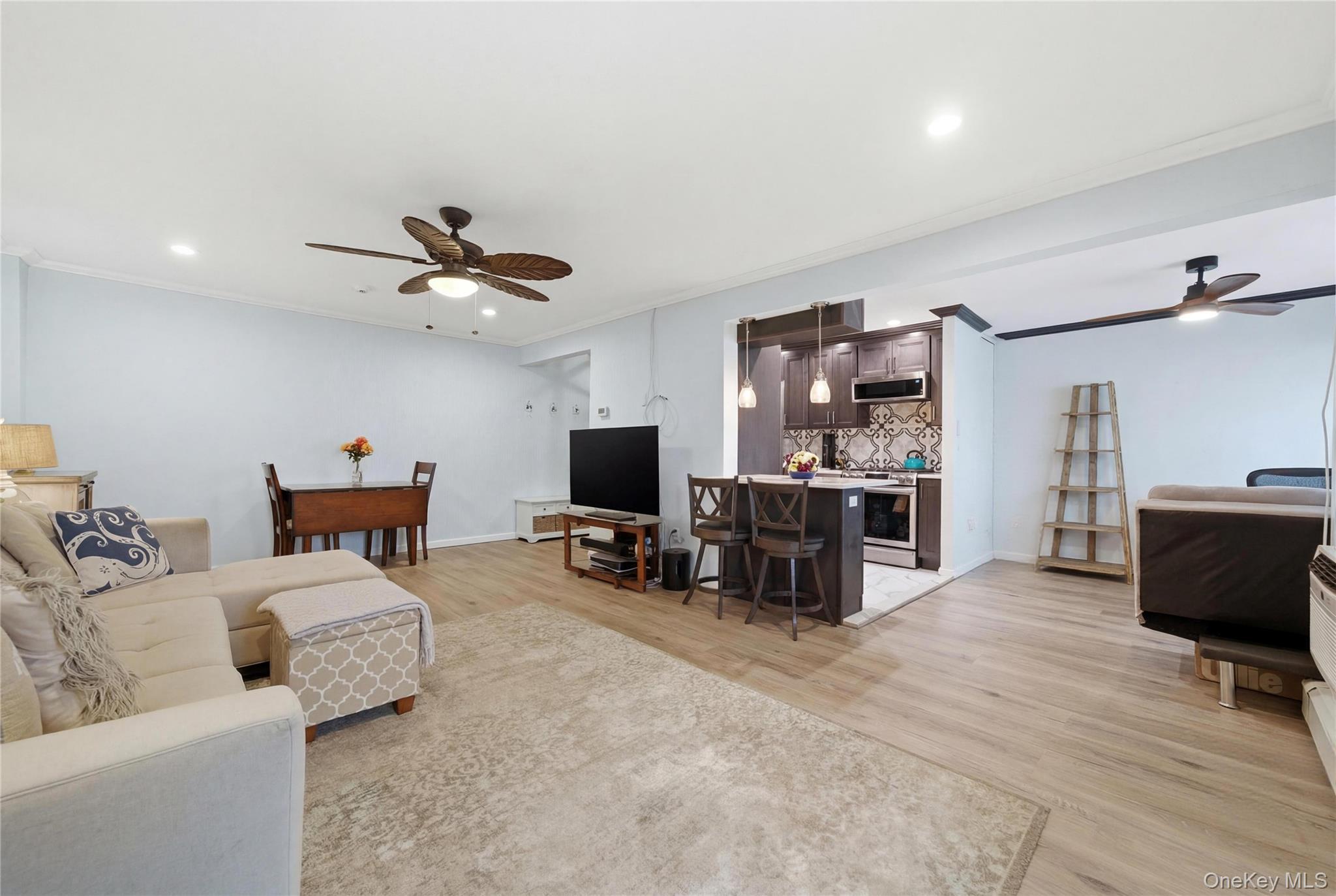 420 Shore Road, Unit 3M Long Beach, NY 11561 - Photo 5 of 21 Living room featuring ceiling fan, crown molding, light wood-type flooring, and recessed lighting