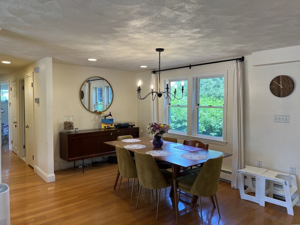 11 Garrison Road, Unit 1 Arlington, MA 02474 - Photo 11 of 42 a view of a dining room with furniture and wooden floor