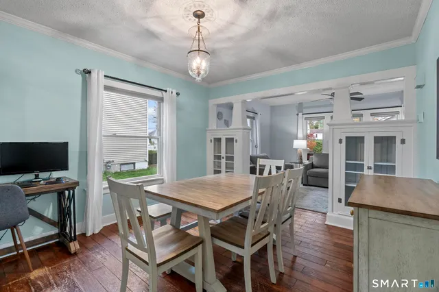 a view of a dining room with furniture window and wooden floor