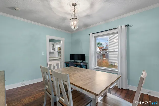 a view of a dining room with furniture wooden floor and chandelier