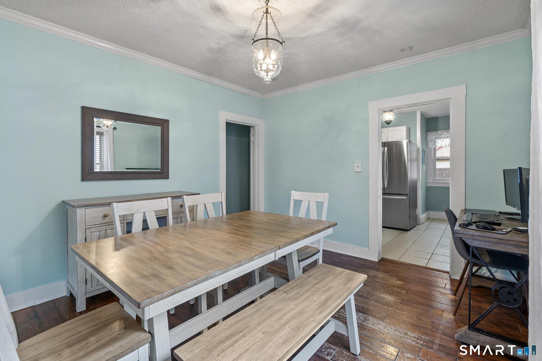 64 Douglas Road Bristol, CT 06010 - Photo 15 of 40 a living room with a table chairs and wooden floor