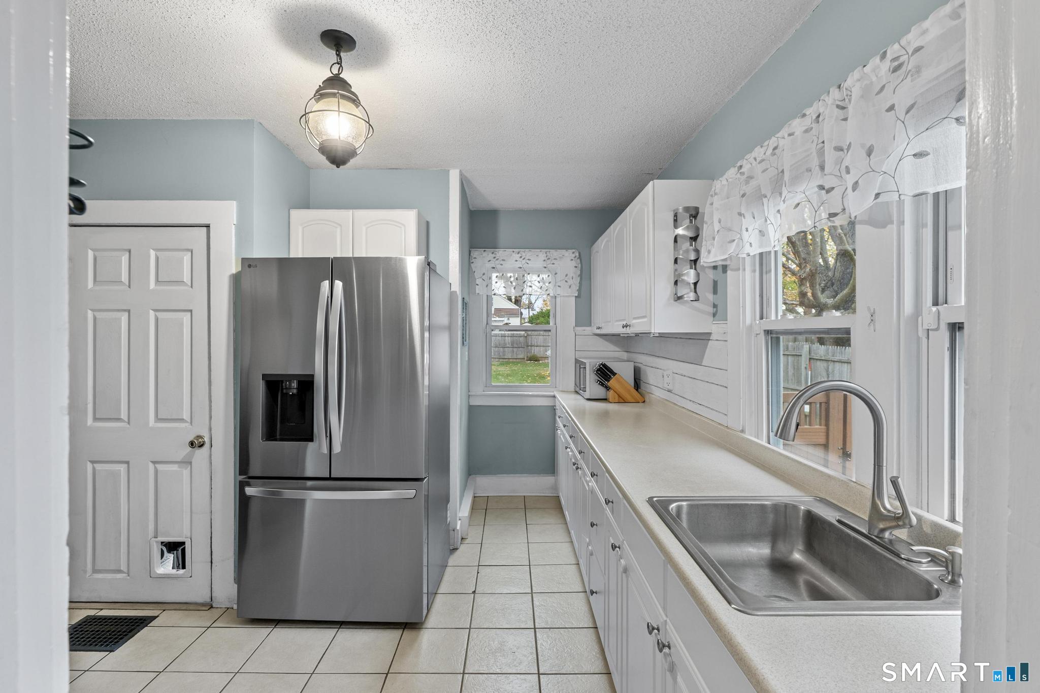 64 Douglas Road Bristol, CT 06010 - Photo 18 of 40 a kitchen with a refrigerator sink and cabinets