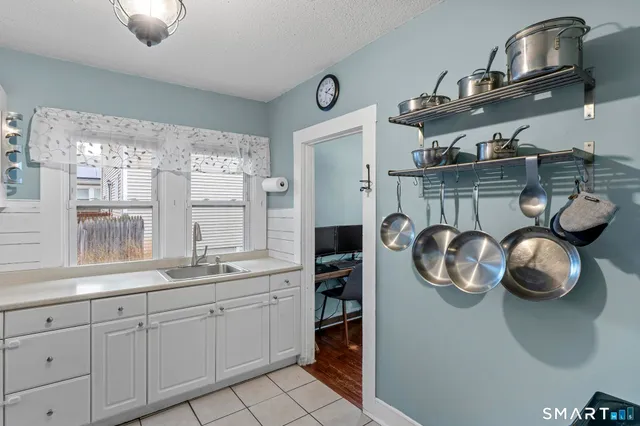 a kitchen with a stove and a wooden floor