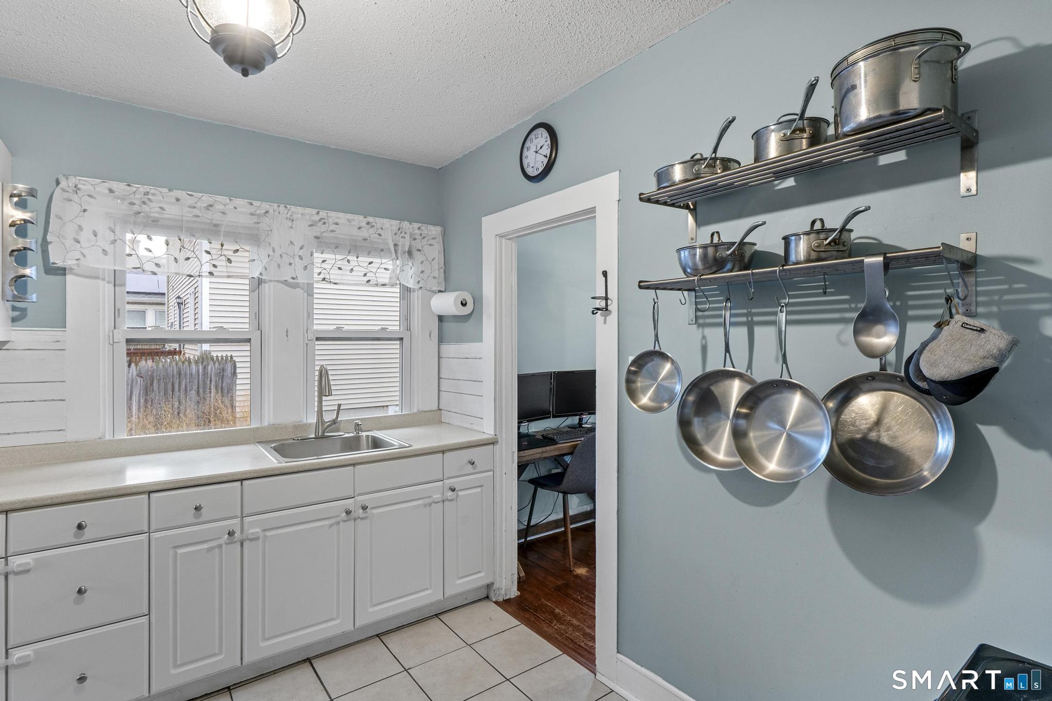 64 Douglas Road Bristol, CT 06010 - Photo 20 of 40 a kitchen with a stove and a wooden floor