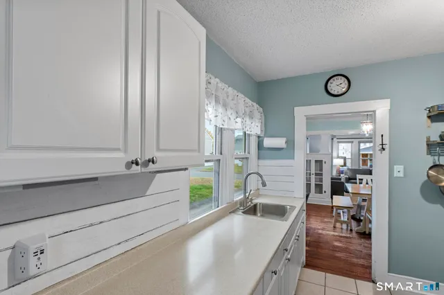 a view of living room with furniture and wooden floor