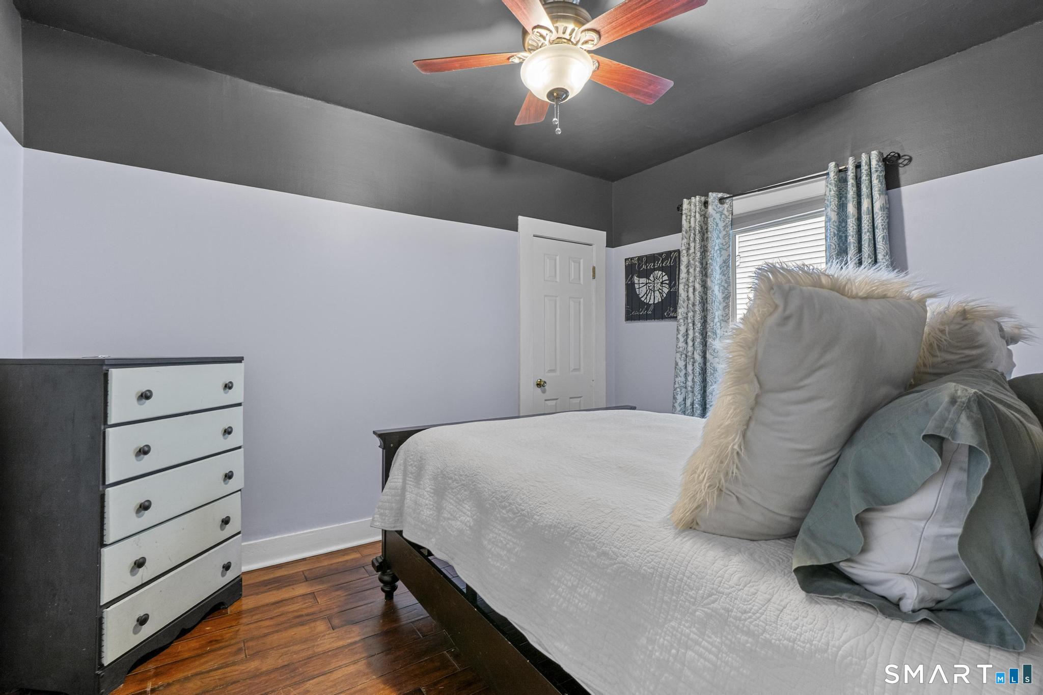 64 Douglas Road Bristol, CT 06010 - Photo 23 of 40 a bedroom with a bed and a chandelier