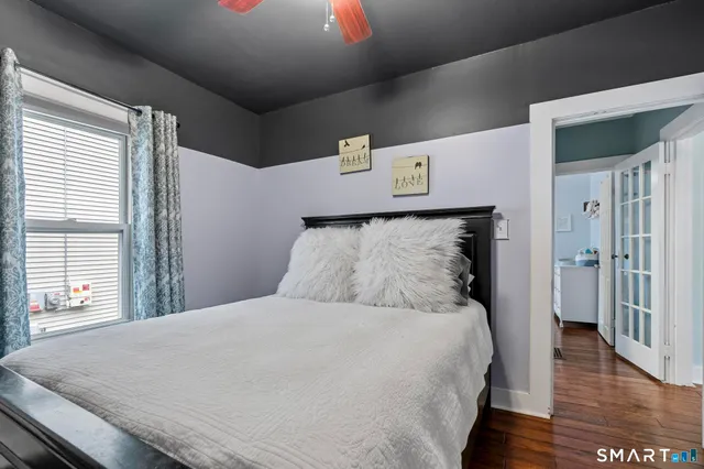 a large bed sitting in a bedroom next to a window