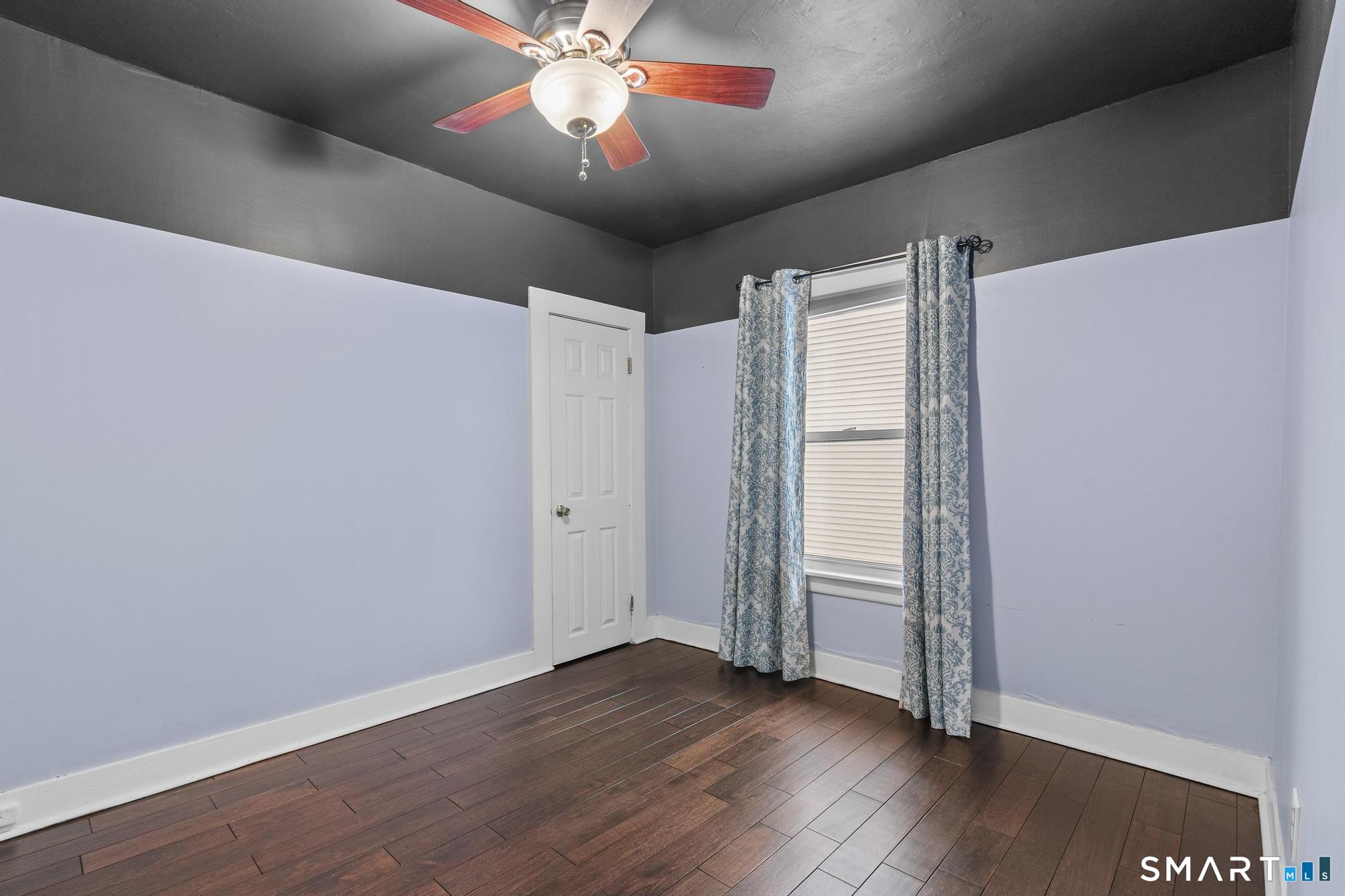 64 Douglas Road Bristol, CT 06010 - Photo 26 of 40 an empty room with wooden floor and windows