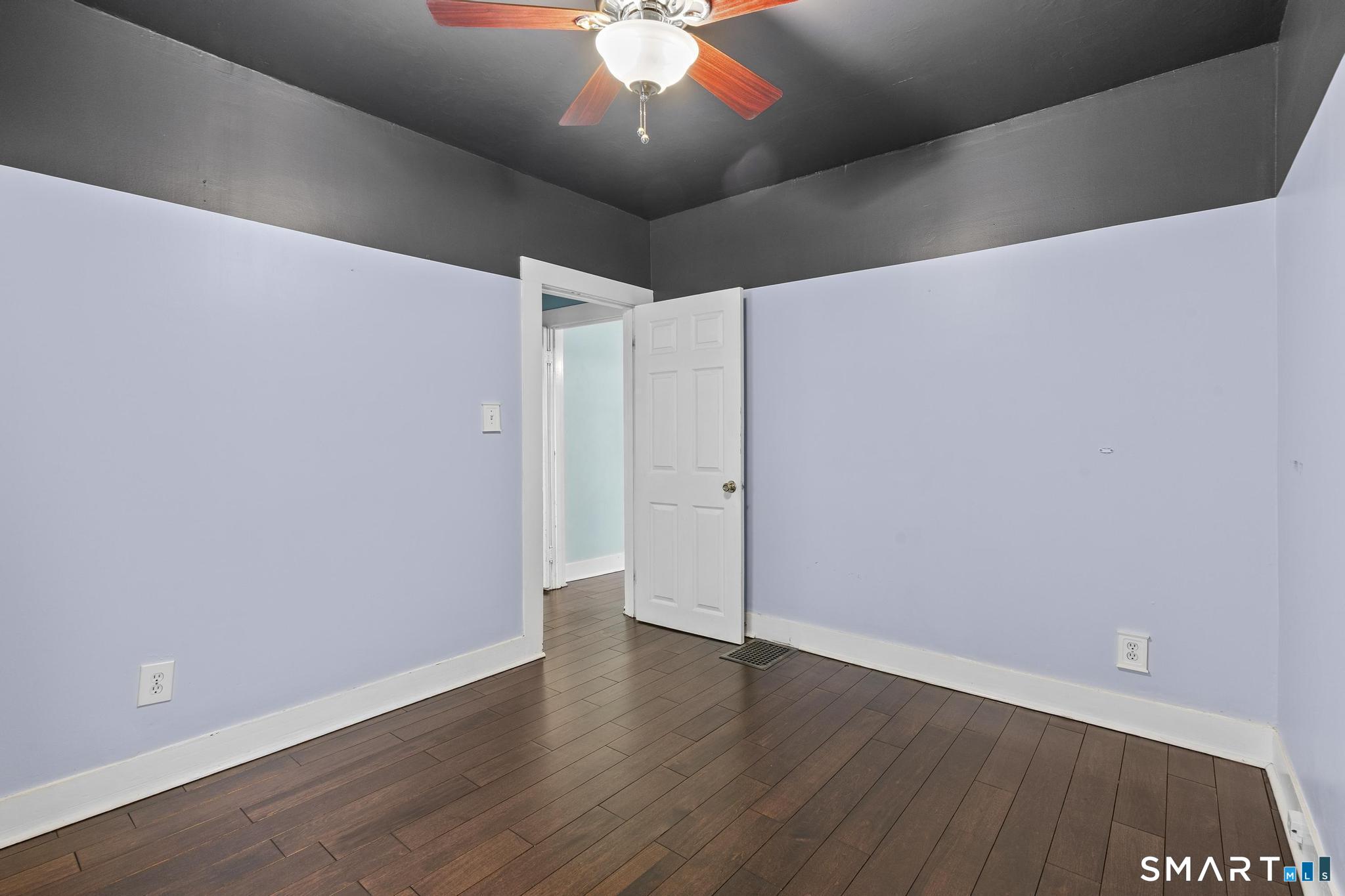 64 Douglas Road Bristol, CT 06010 - Photo 27 of 40 an empty room with wooden floor and windows