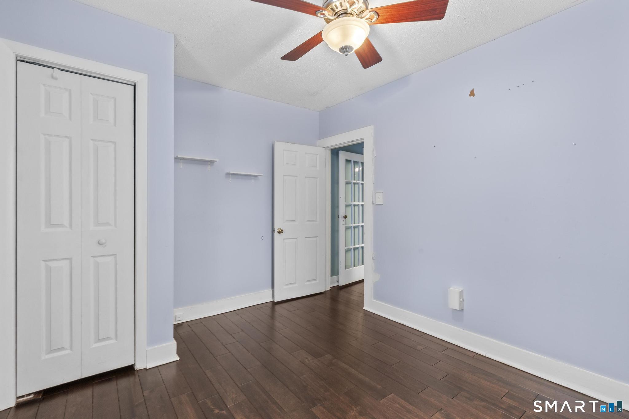 64 Douglas Road Bristol, CT 06010 - Photo 33 of 40 an empty room with wooden floor chandelier fan and windows