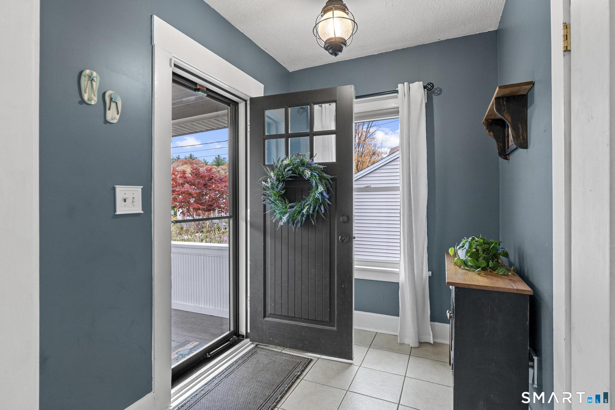 64 Douglas Road Bristol, CT 06010 - Photo 4 of 40 an entryway with a flower pot and a bookshelf