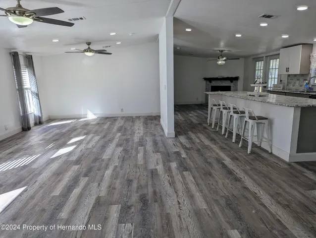 a view of kitchen with sink microwave and refrigerator