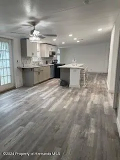 a large kitchen with a sink cabinets and stainless steel appliances
