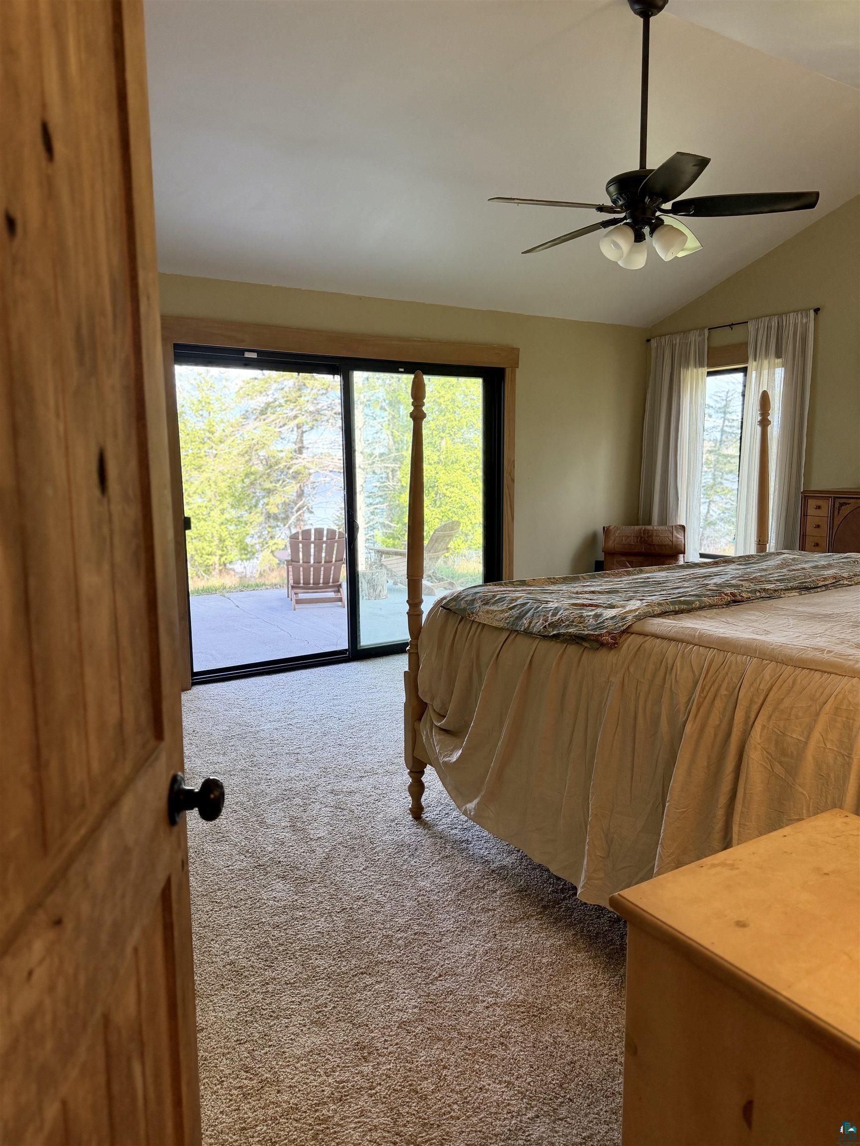 5274 Marble Lake Road Two Harbors, MN 55616 - Photo 30 of 79 Carpeted interior space featuring a vaulted ceiling and a ceiling fan with integrated lighting