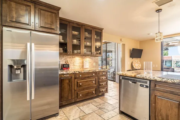 a kitchen with a granite countertop stove sink and cabinets