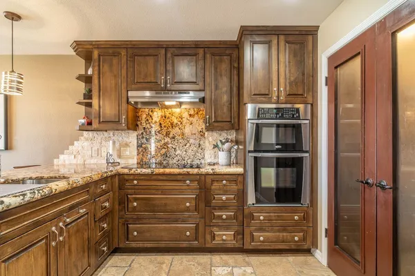 a bedroom with a large bed and a chandelier