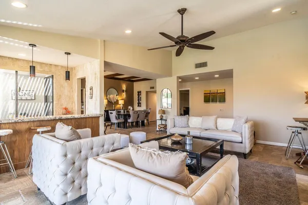a living room with furniture and a chandelier