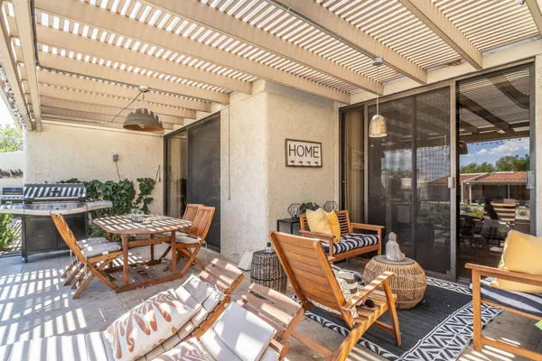a view of a patio with table and chairs and potted plants