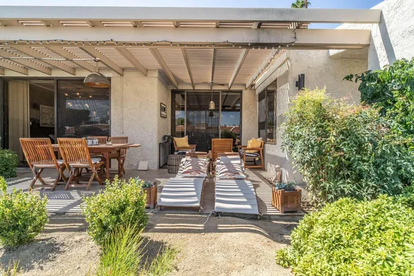 a view of a balcony with table and chairs