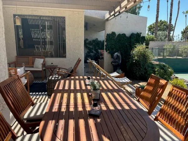 a view of a patio with table and chairs under an umbrella
