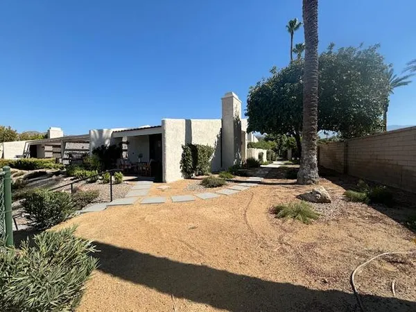 a swimming pool view with a seating space