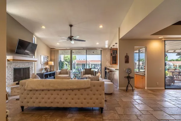 a living room with furniture a fireplace and a flat screen tv