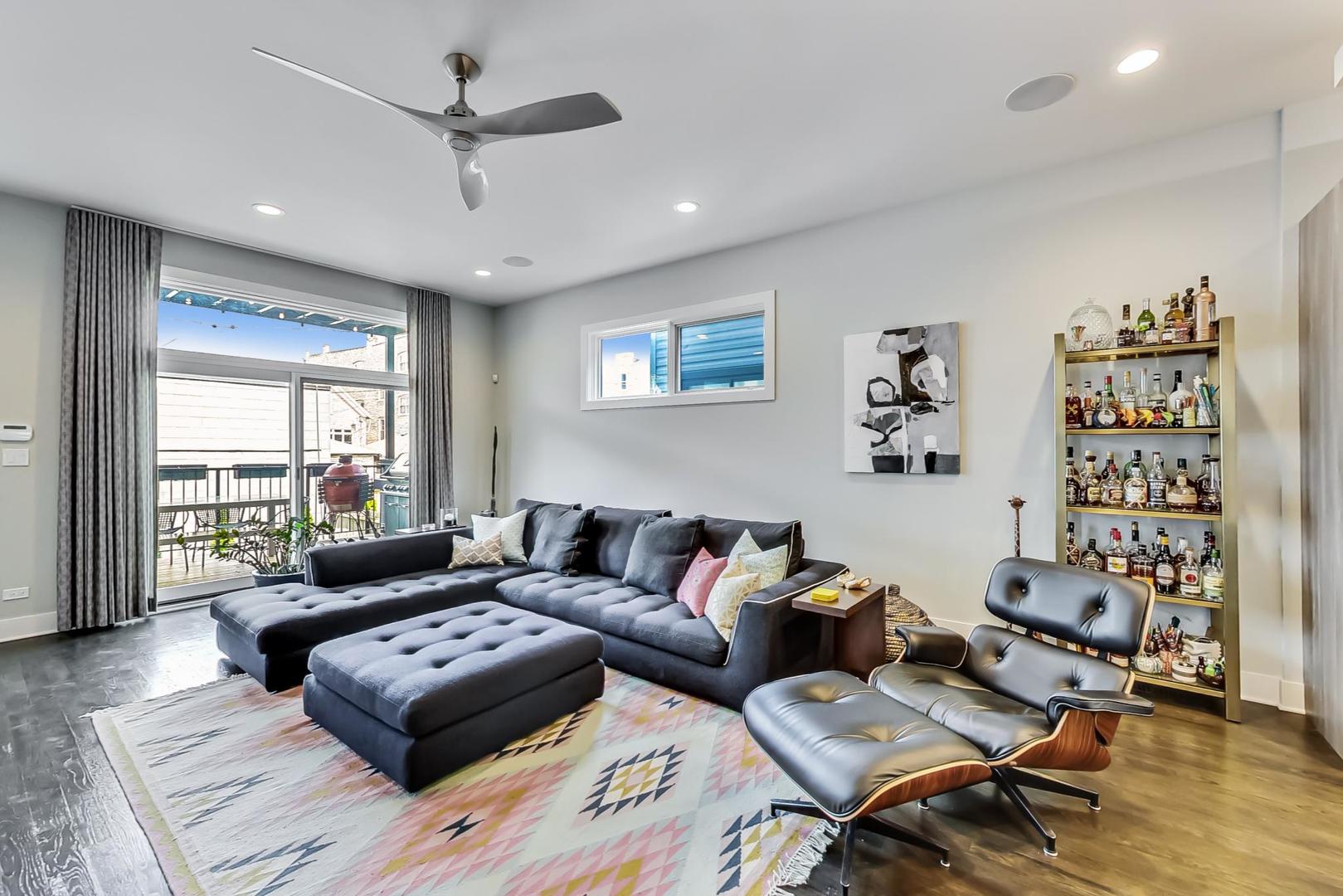 2030 West Rice Street, Unit 1 Chicago, IL 60622 - Photo 4 of 37 a living room with furniture a rug and a chandelier
