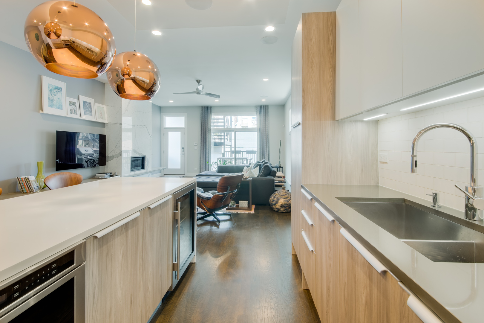 2030 West Rice Street, Unit 1 Chicago, IL 60622 - Photo 10 of 37 a kitchen with a sink dishwasher a stove and a dining table with wooden floor