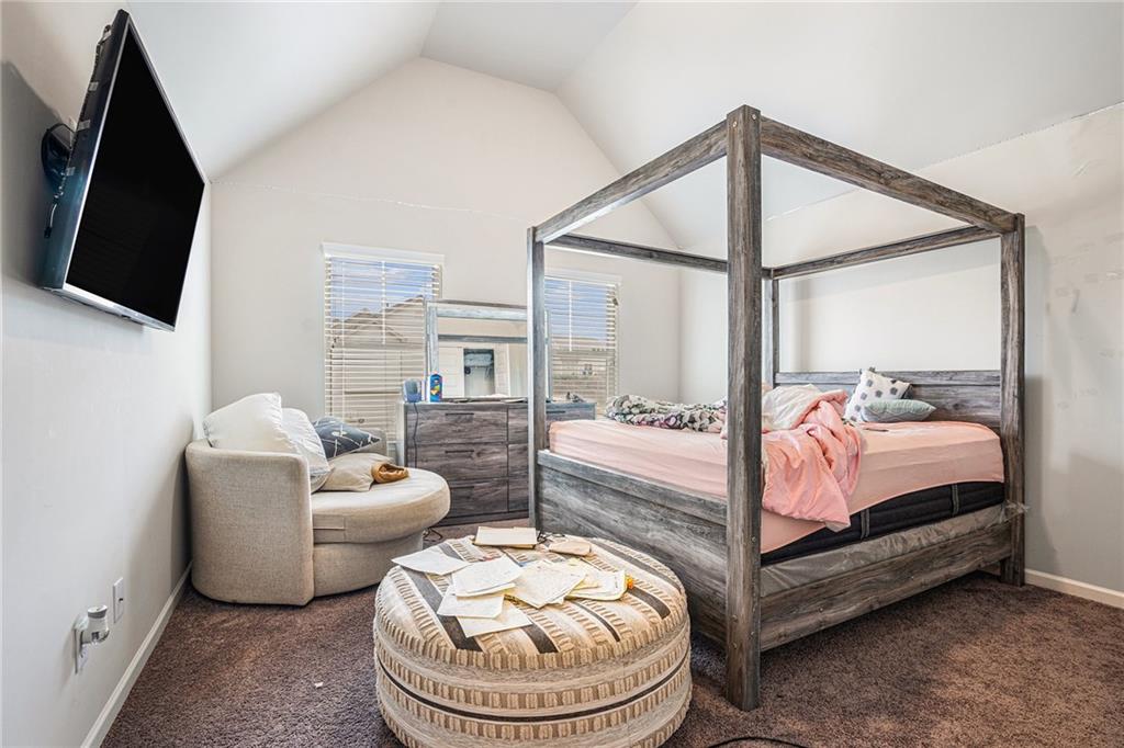 2428 Hanover Woods Road Lithonia, GA 30058 - Photo 11 of 26 a bedroom with a bed and a flat screen tv