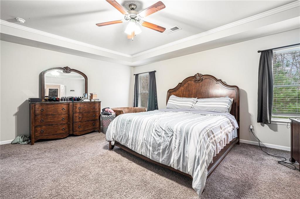 2428 Hanover Woods Road Lithonia, GA 30058 - Photo 13 of 26 a bedroom with a bed and a chandelier