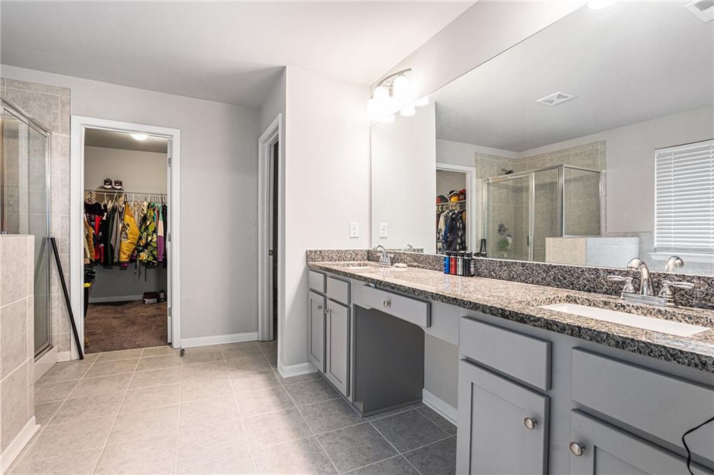 2428 Hanover Woods Road Lithonia, GA 30058 - Photo 16 of 26 a bathroom with a sink and a mirror