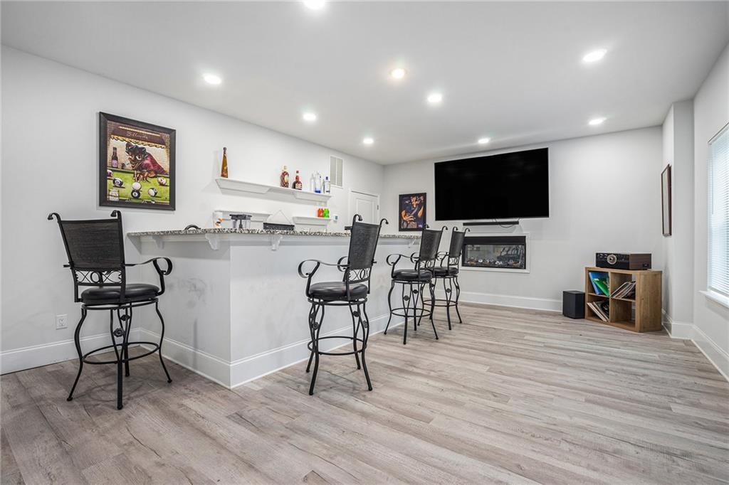 2428 Hanover Woods Road Lithonia, GA 30058 - Photo 19 of 26 a view of a dining room with furniture window and wooden floor