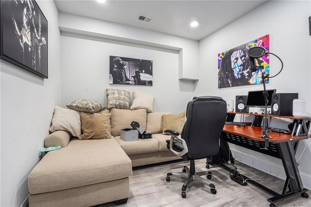 2428 Hanover Woods Road Lithonia, GA 30058 - Photo 21 of 26 a living room with furniture and a bookshelf