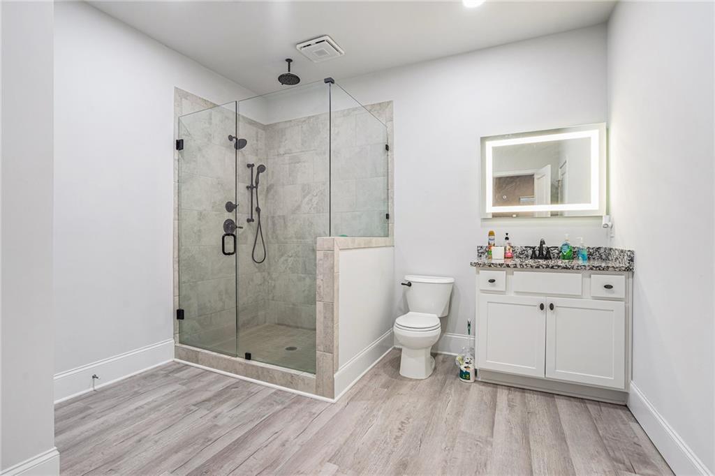 2428 Hanover Woods Road Lithonia, GA 30058 - Photo 23 of 26 a bathroom with a sink a toilet and shower