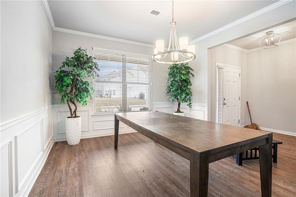2428 Hanover Woods Road Lithonia, GA 30058 - Photo 4 of 26 a view of a dining room with furniture window and wooden floor