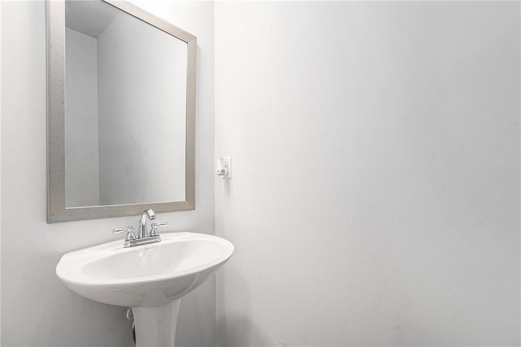 2428 Hanover Woods Road Lithonia, GA 30058 - Photo 9 of 26 a bathroom with a sink and a mirror