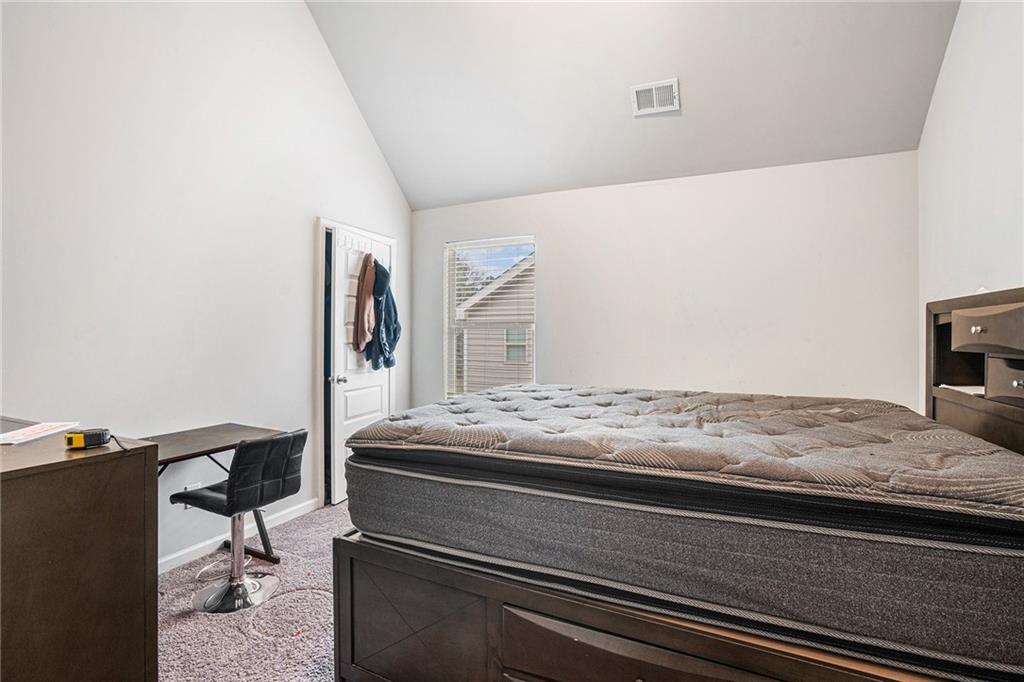 2428 Hanover Woods Road Lithonia, GA 30058 - Photo 10 of 26 a bedroom with a bed and a dresser in it
