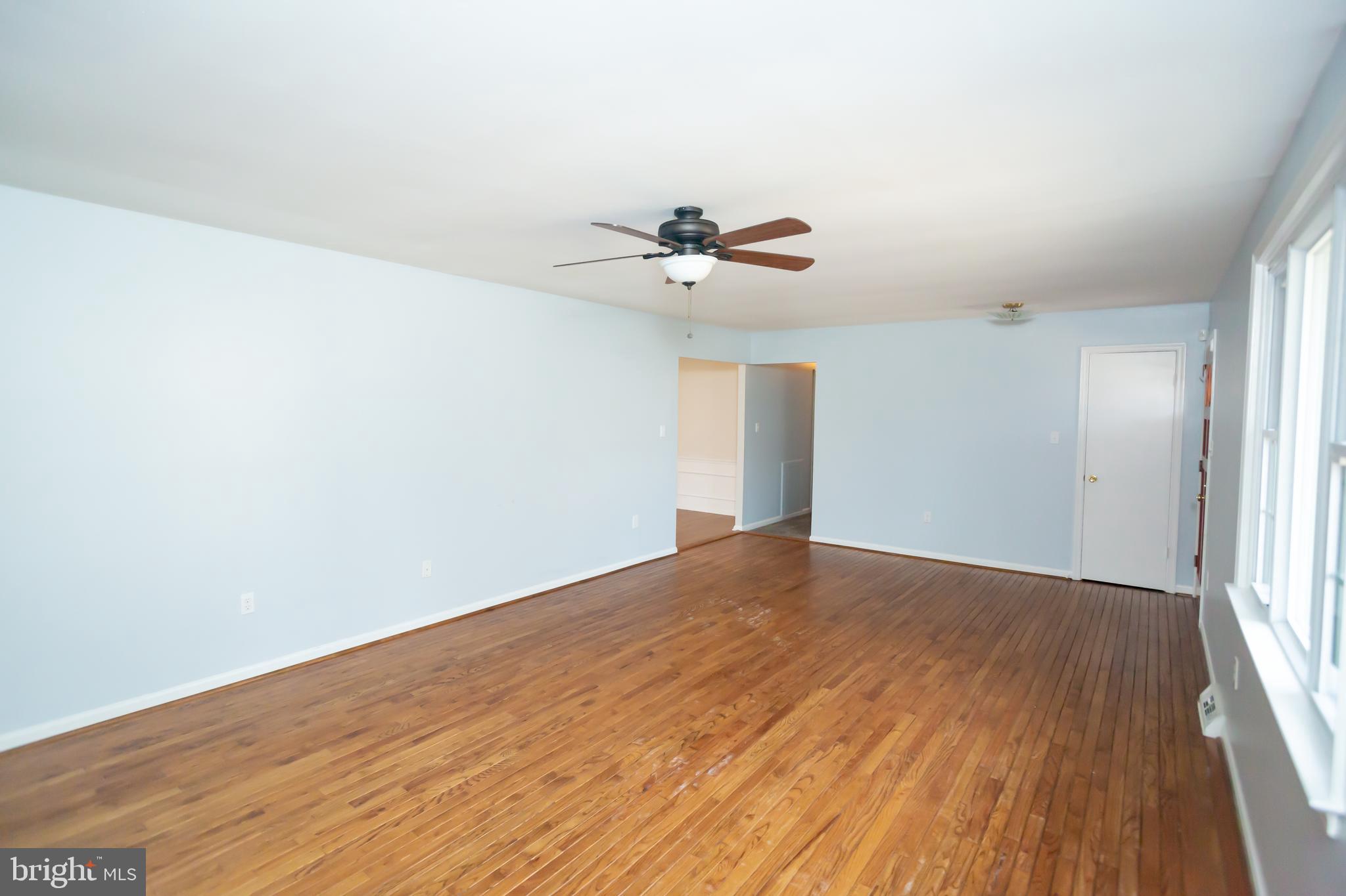 11623 Rivershore Drive Dunkirk, MD 20754 - Photo 6 of 49 a view of a big room with wooden floor and a ceiling fan