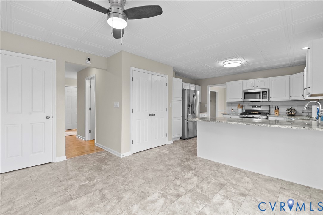 842 Hardtimes Road Farmville, VA 23901 - Photo 17 of 50 Kitchen featuring light stone countertops, a penin