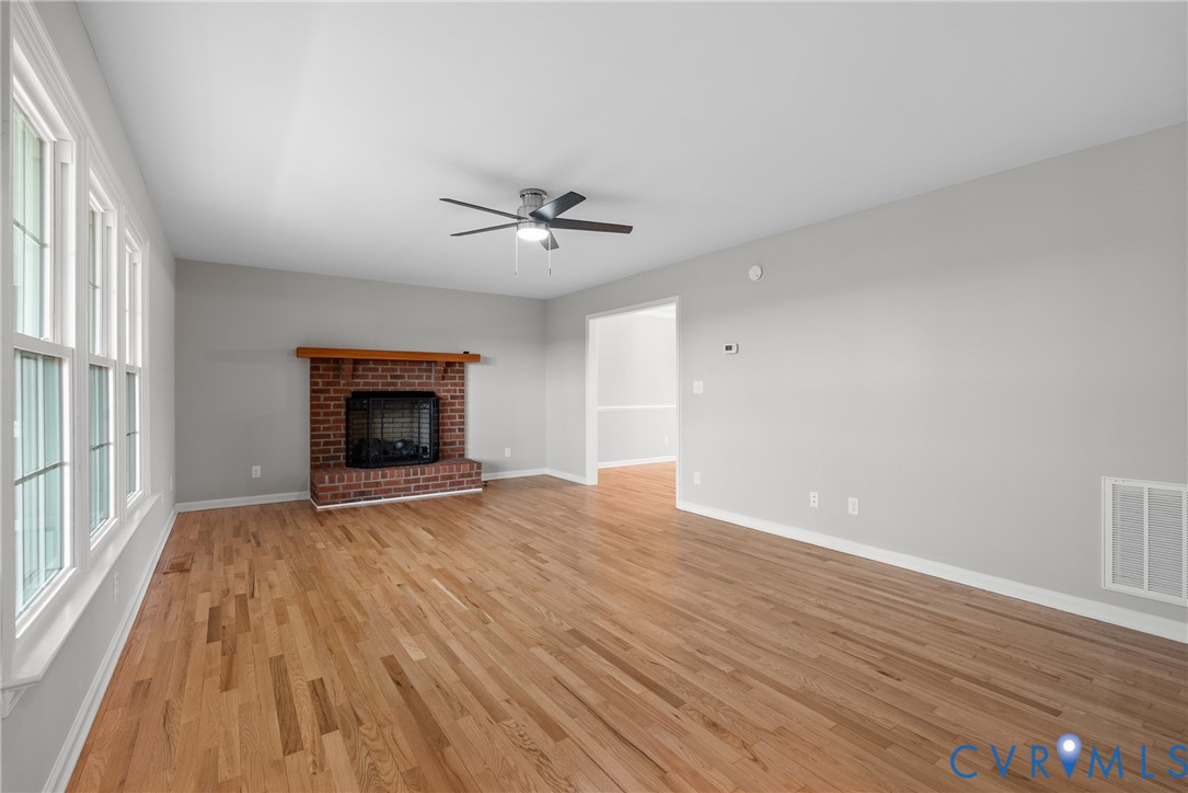 842 Hardtimes Road Farmville, VA 23901 - Photo 5 of 50 Unfurnished living room with a fireplace, light wo