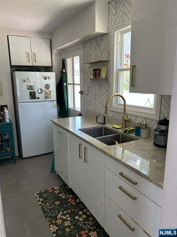 441 New Bridge Road Bergenfield, NJ 07621 - Photo 5 of 11 a kitchen with sink refrigerator and window