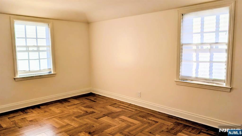 441 New Bridge Road Bergenfield, NJ 07621 - Photo 8 of 11 an empty room with windows