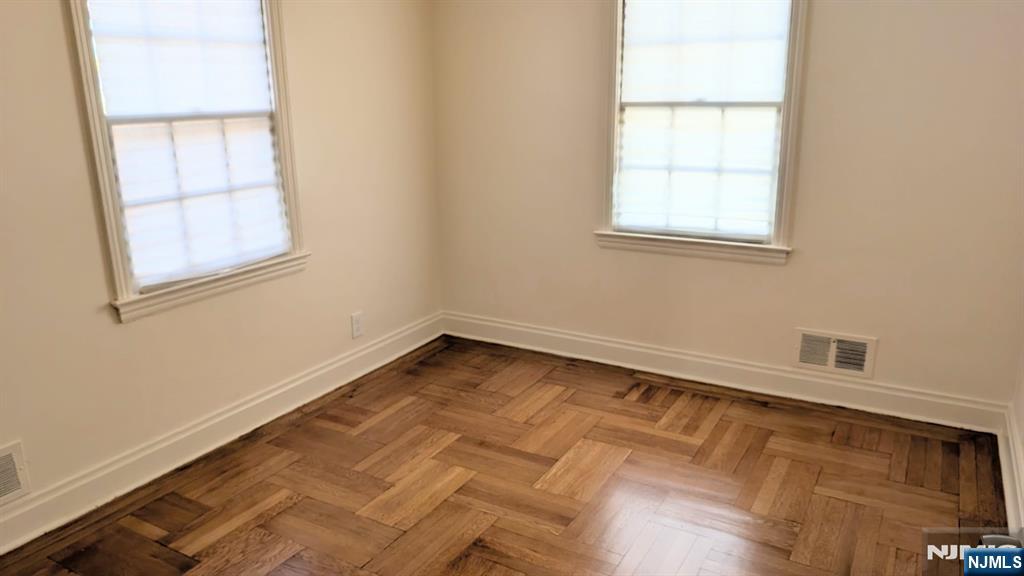 441 New Bridge Road Bergenfield, NJ 07621 - Photo 9 of 11 an empty room with windows