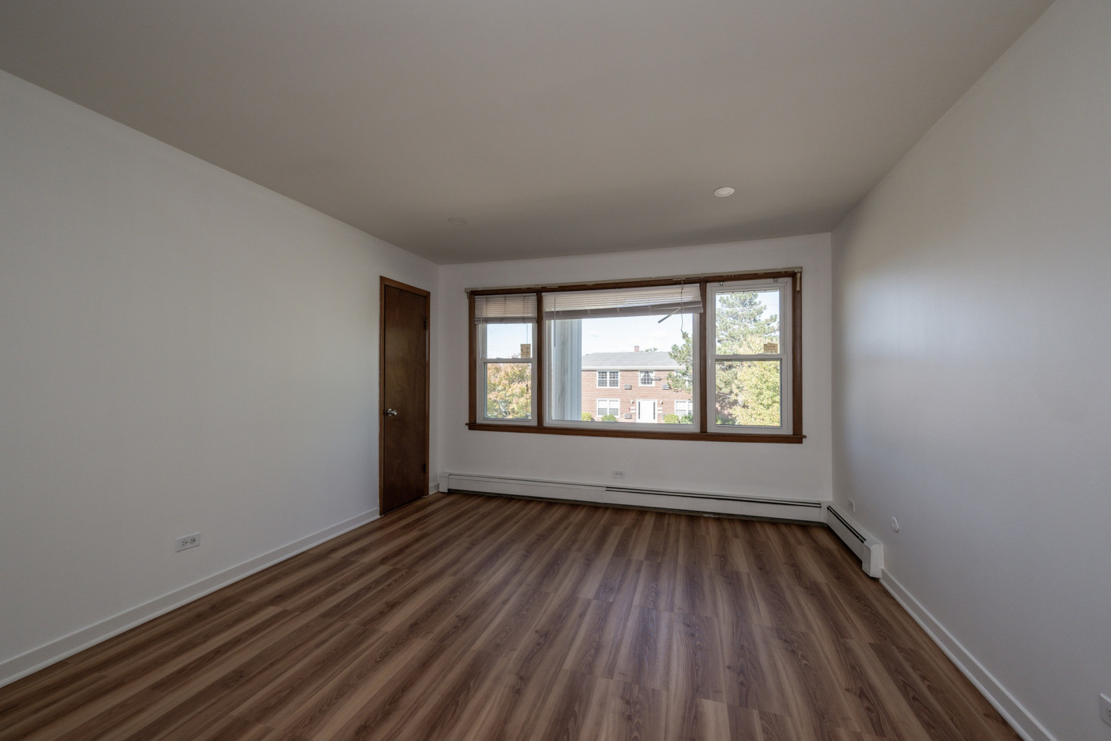 14450 Jefferson Avenue, Unit 2E Orland Park, IL 60462 - Photo 3 of 8 wooden floor in an empty room with a window